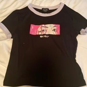 I am selling a black shirt with an animated  face with some writing.